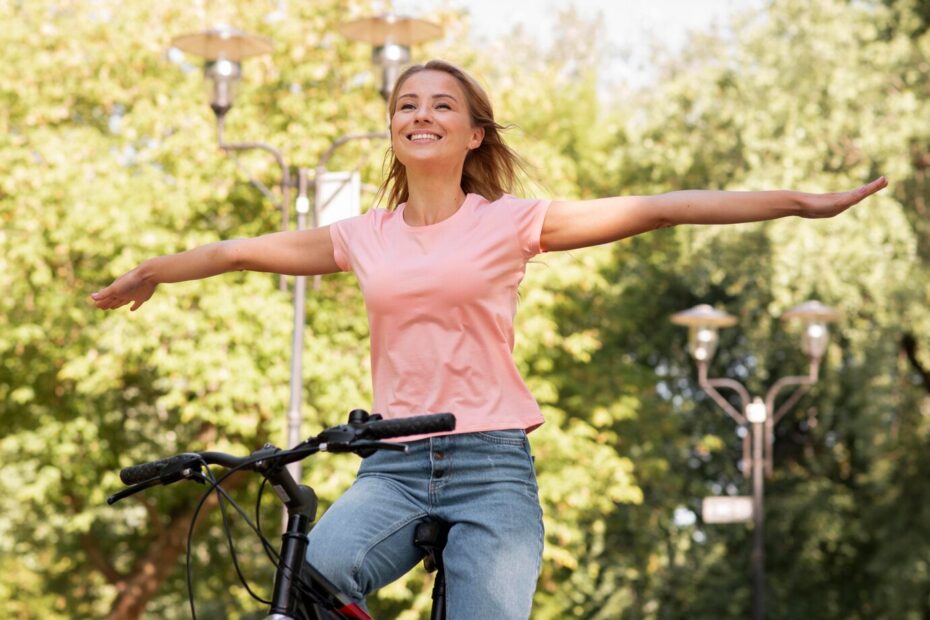 low view woman riding without holding bike with hands 23 2148684612